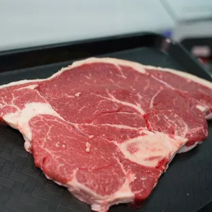 a piece of beef on a black tray
