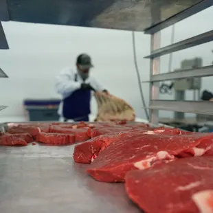 Beef Steaks being cut and prepped for packaging.
