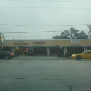 a yellow car parked in front of a store