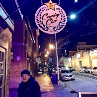 a man standing in front of a restaurant