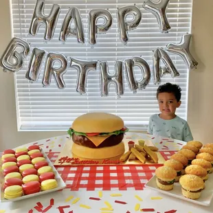 Burger cake, macarons, and cupcakes all by One Stop