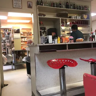 a counter with stools in front of it