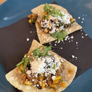 Carne asada with corn nacho amuse bouche.