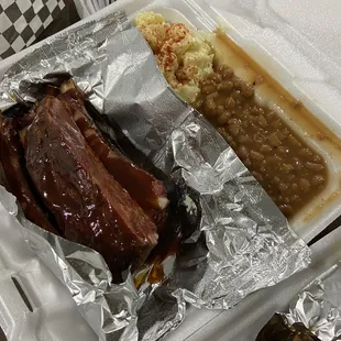 Rib plate dish potatoes salad and baked beans