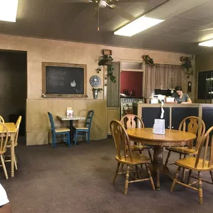 a dining area with tables and chairs