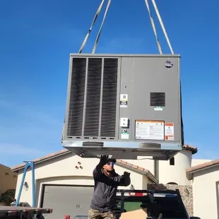 Installation of 5 ton package unit at a home using crane.