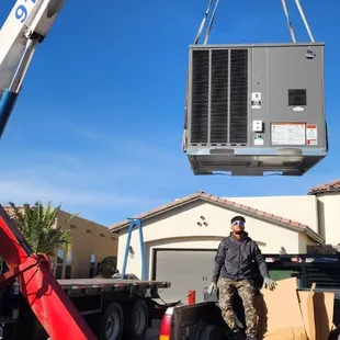 Installation of 5 ton package unit at a home using crane.