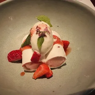 a dessert with strawberries and ice cream