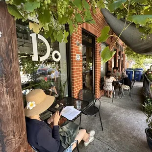 a man sitting in a chair under a tree