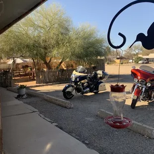 two motorcycles parked in a parking lot