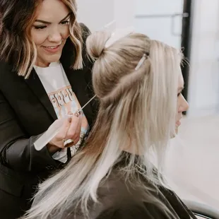 Sarah Boyce applying hand tied extensions