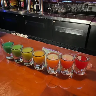 a row of juices on a bar