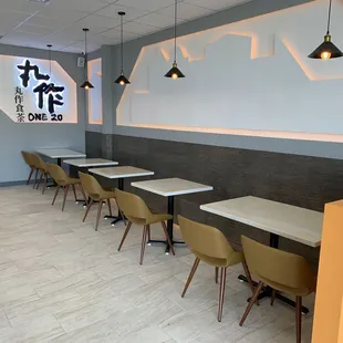 a row of tables and chairs in a restaurant