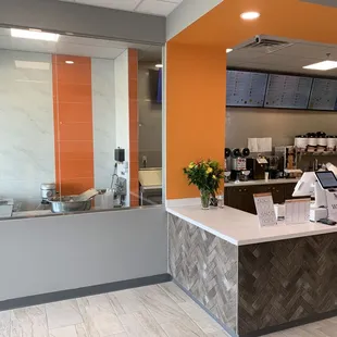 a coffee shop with a counter and orange walls