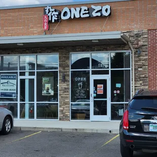 two cars parked in front of the store