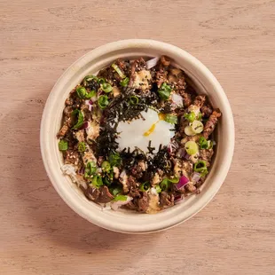 a bowl of food on a wooden table