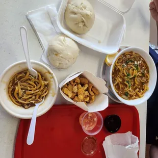 a tray of food and a woman eating