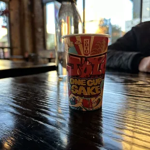 a cup of coffee on a wooden table