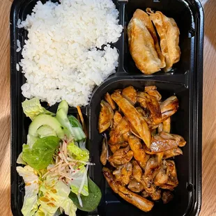a meal of chicken, rice, lettuce, and salad