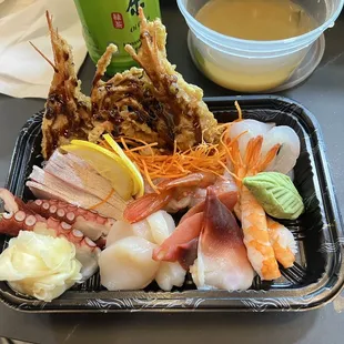 a tray of sushi and a cup of tea
