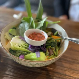 a bowl of vegetables and sauce