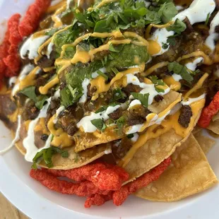 51/50 nachos include tortillas chips,meat of your choice,beans,nacho cheese,sour cream,guacamole,salsa,onions and cilantro