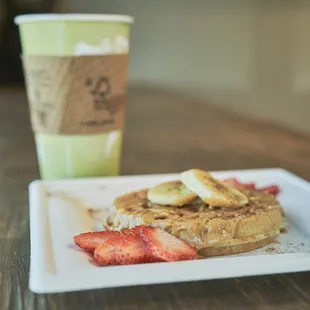 a plate of waffles and strawberries