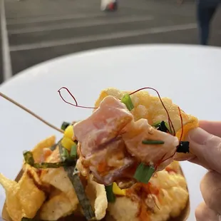 a person holding a piece of food