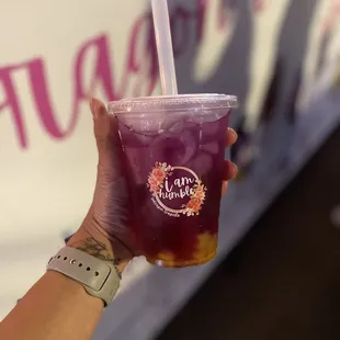a hand holding a drink