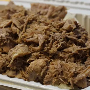 shredded pork in a styrofoam container