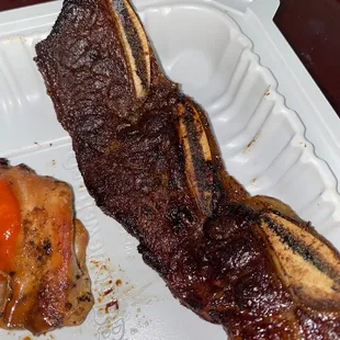 a close up of a piece of meat on a styrofoam container