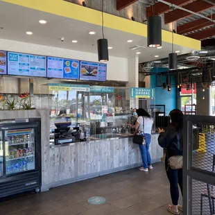 Counter area, and a large seating space to eat inside.  Drinks in cans and fountain dispenser.