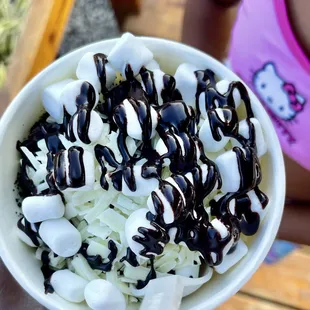 a bowl of marshmallows and chocolate sauce