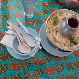 a bowl of soup and spoons