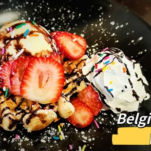 a waffle with strawberries and whipped cream