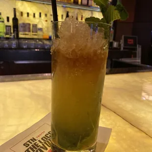 a tall glass filled with a drink