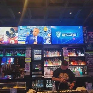 a man standing behind the bar