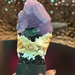 Ube (purple) and coconut (black) ice cream in toasted waffle cone
