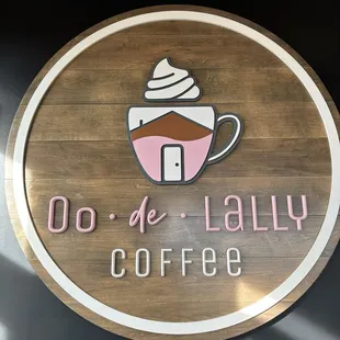ows a cup of coffee on a wooden sign