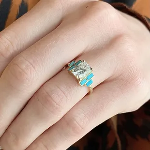 The Sonora! 2.04 carat radiant cut moissanite and turquoise baguettes in yellow gold.