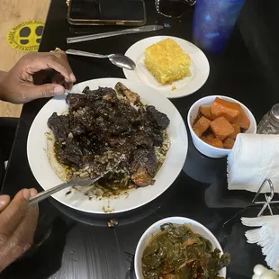 Jerk oxtails greens and yams