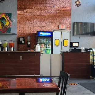 Open dining area, bar view and take out register view.