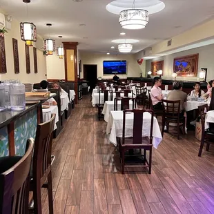 people sitting at tables in a restaurant