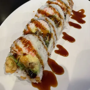 a plate of sushi with sauce on it