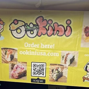 a woman standing in front of a sign