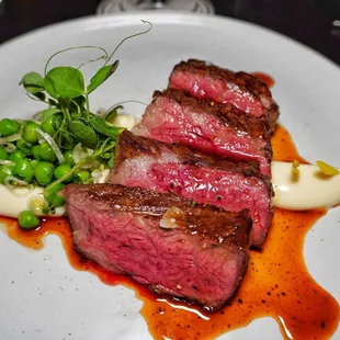 Wagyu zabuton with taleggio parsnips puree, green pea and peppercorn demi