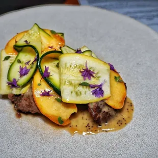 Pork cheeks in a poppy seed allemande with shaved summer squash, peaches and marjoram