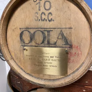 a wooden barrel with a plaque on it