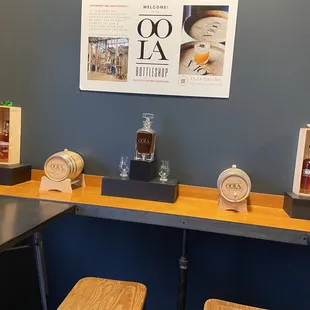 a counter with two stools and a clock