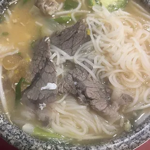 Stone Pho- steak rib, rare steak, brisket, tendon, beef meatball, served with a raw egg that you crack into the soup. #GucciPho